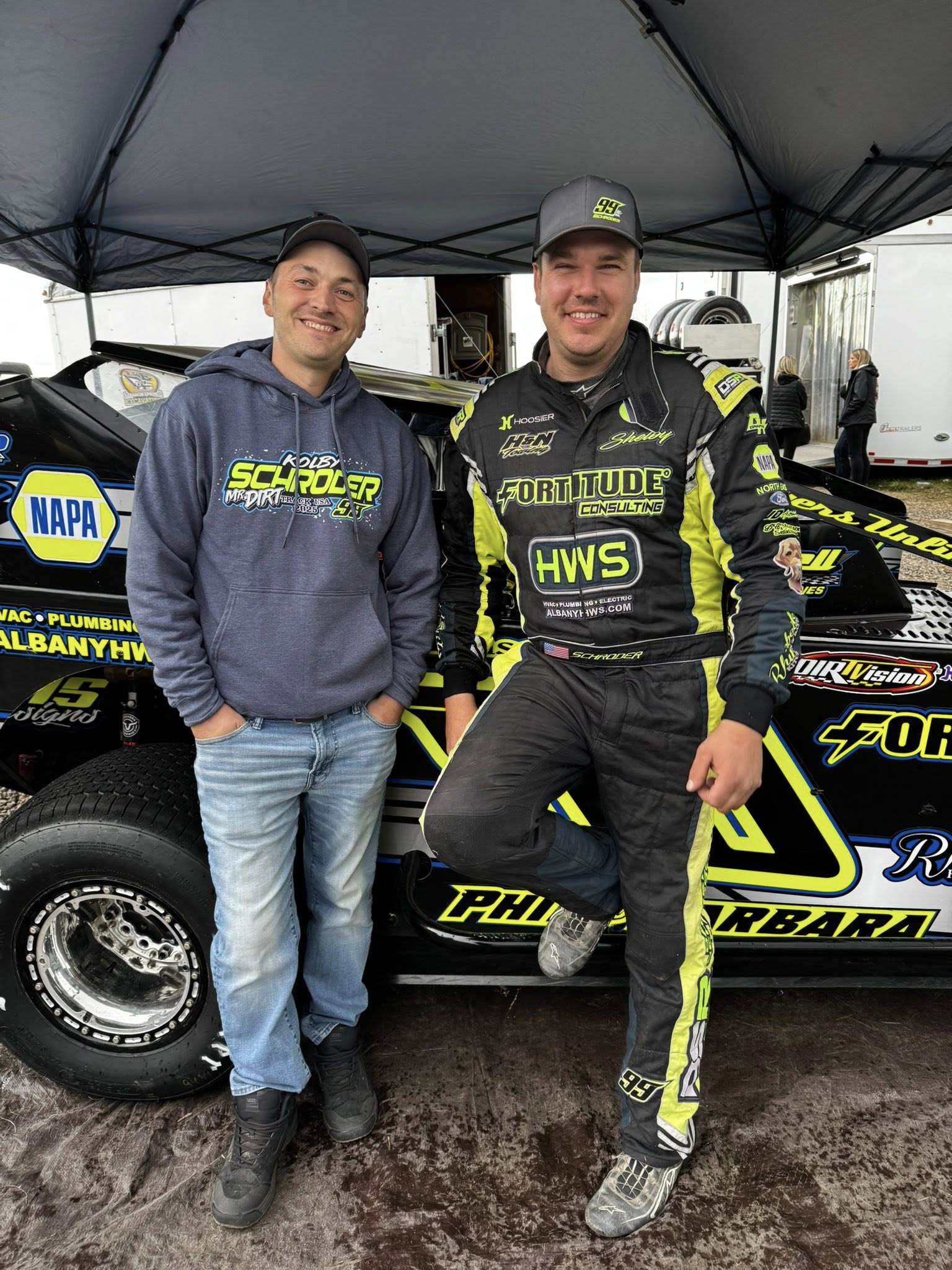 Kolby with his dad in Schroeder hoodie in the pit area wearing Fortitude fire suit